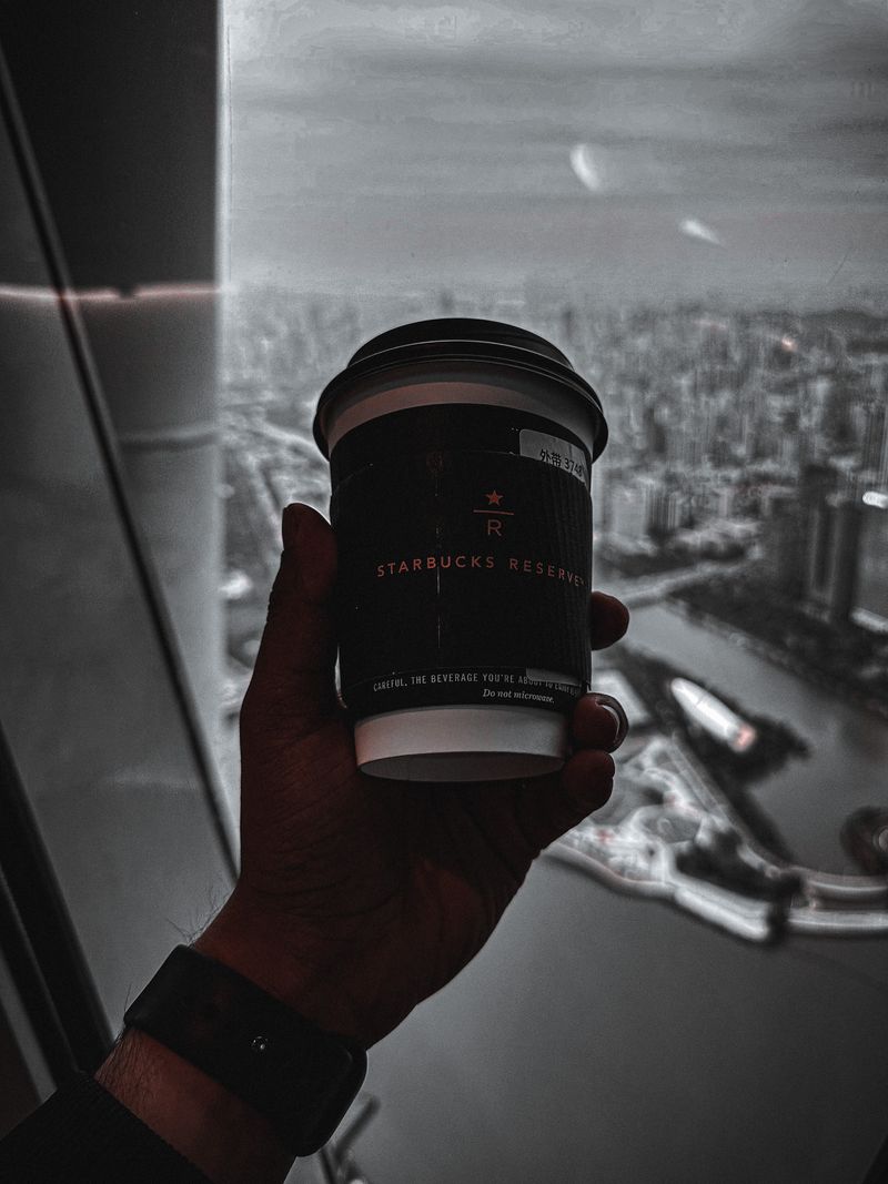 Starting my day with a sip of Starbucks and a stunning view of Guangzhou from Canton Tower